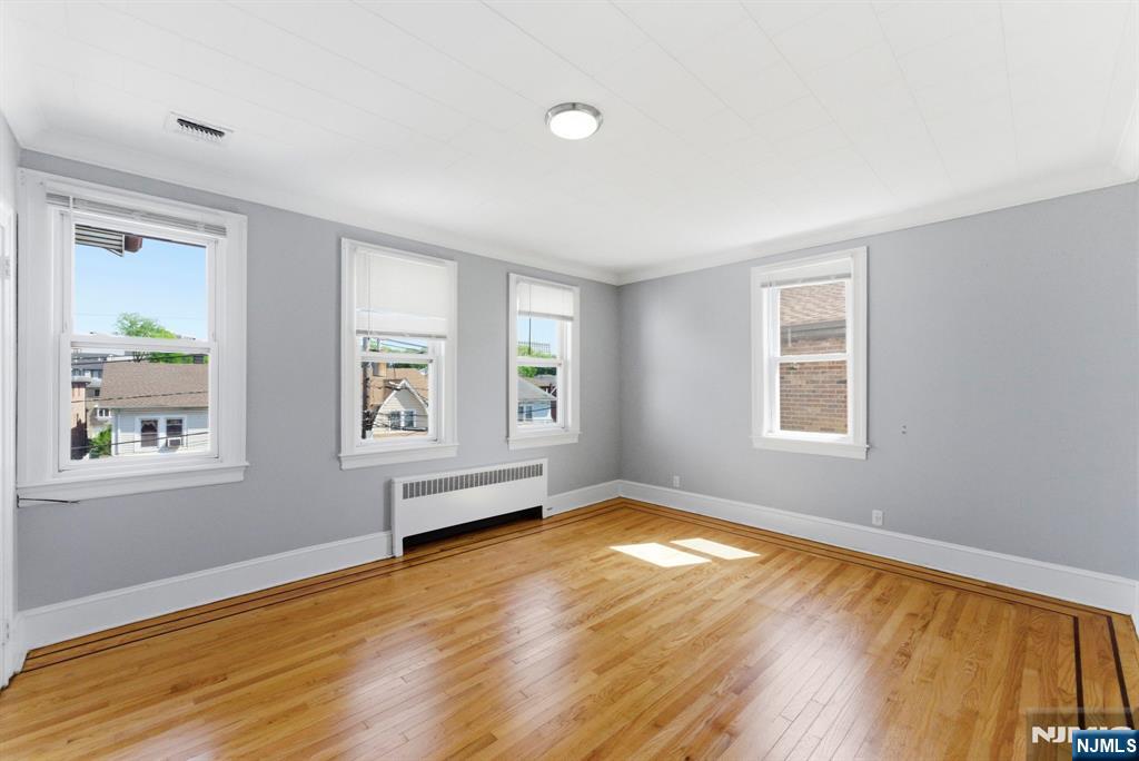 773 Kingsland Avenue Ridgefield, NJ 07657 - Photo 8 of 13 a view of an empty room with wooden floor and a window