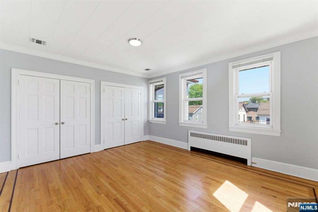 773 Kingsland Avenue Ridgefield, NJ 07657 - Photo 9 of 13 a view of an empty room with wooden floor and a window