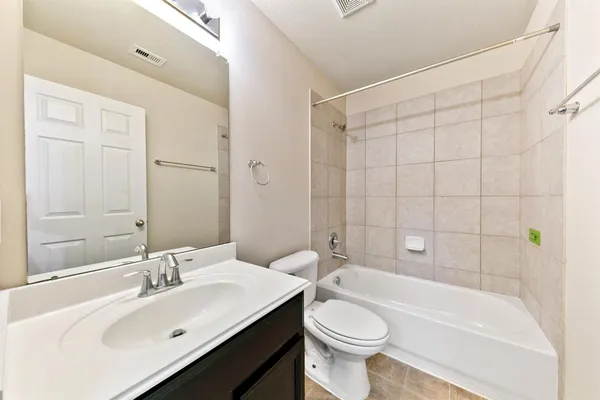 a bathroom with a sink a toilet and bathtub