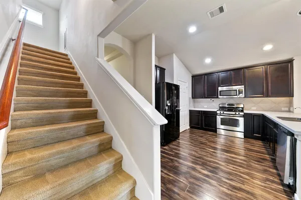 a kitchen with sink microwave and stove