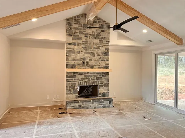 a view of an empty room and fire place