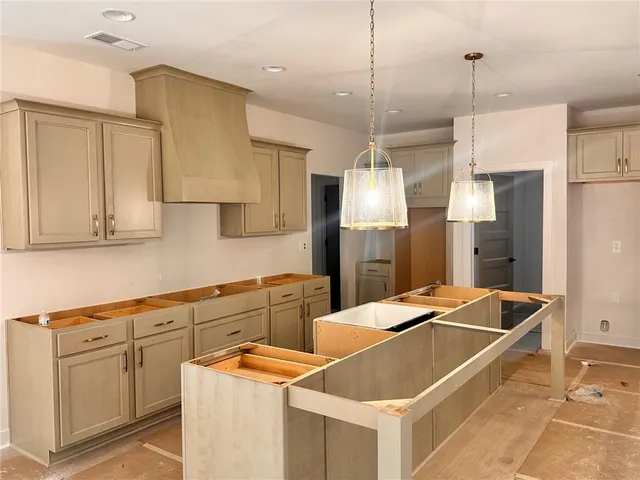 a kitchen with stainless steel appliances granite countertop a sink a refrigerator and a stove