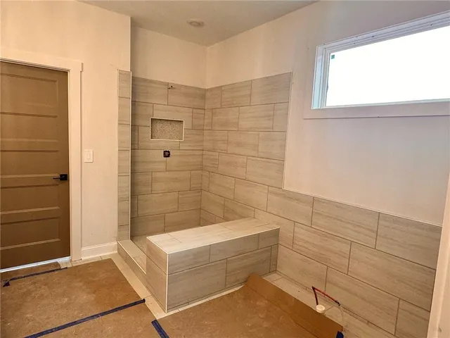 a bathroom with a bathtub and shower