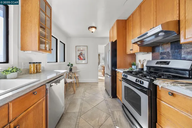 a kitchen with stainless steel appliances granite countertop a stove and a sink