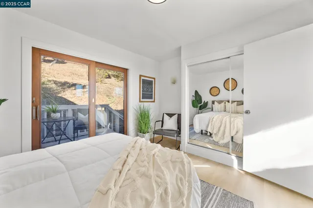 a bedroom with a bed and a large window