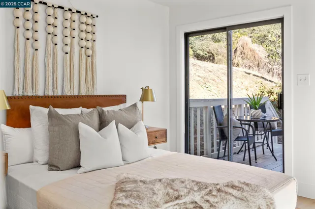 a bedroom with a bed and a large window