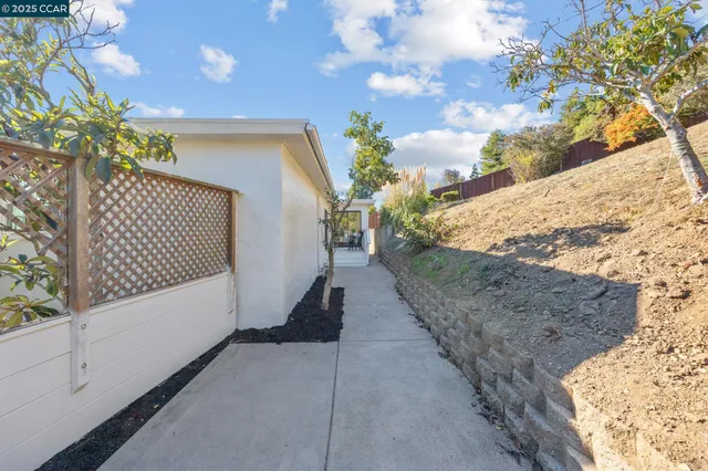 a view of a pathway along with wooden fence