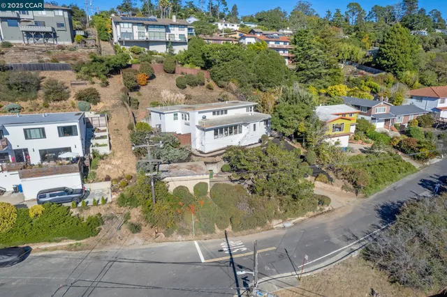an aerial view of residential houses with outdoor space