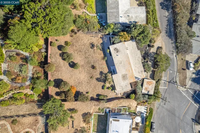 an aerial view of a residential apartment building with a yard