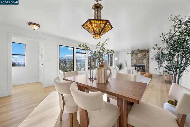 a dining room with furniture a chandelier and wooden floor