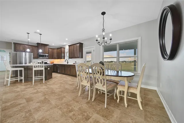 a dining room with furniture and a chandelier