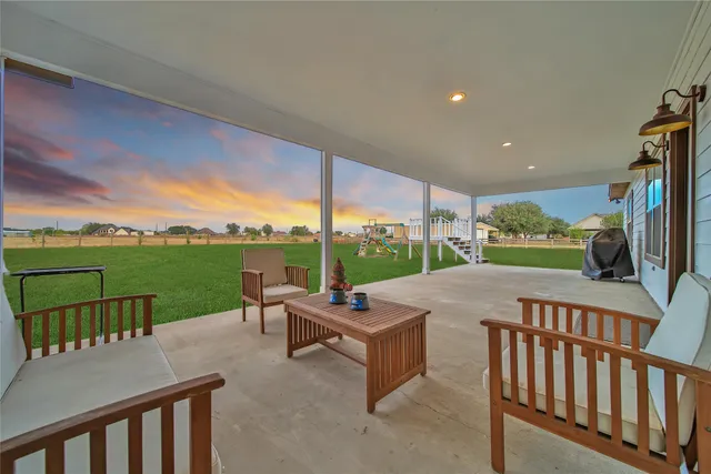a view of a house with a backyard porch and sitting area