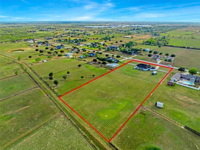 a front view of a house with a garden and yard