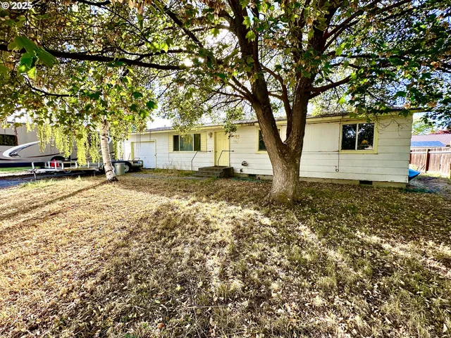 a view of a house with a tree in the background