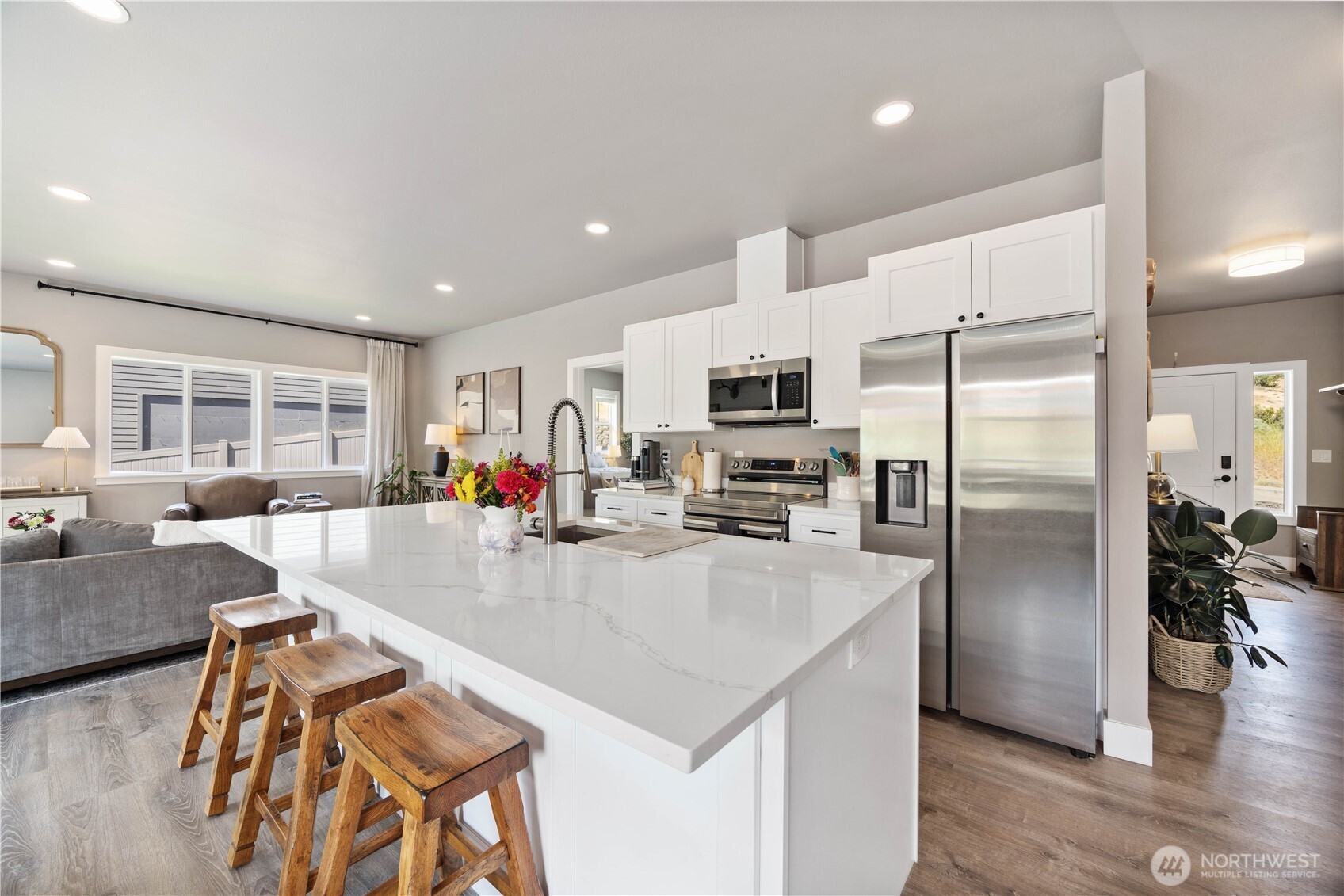 9968 Griffith Place Entiat, WA 98822 - Photo 8 of 38 a kitchen with stainless steel appliances granite countertop a refrigerator a stove a sink a dining table and chairs with wooden floor