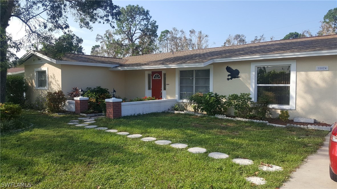 18024 Cypress Point Road Fort Myers, FL 33967 - Photo 2 of 21 a view of a house with backyard sitting area and garden
