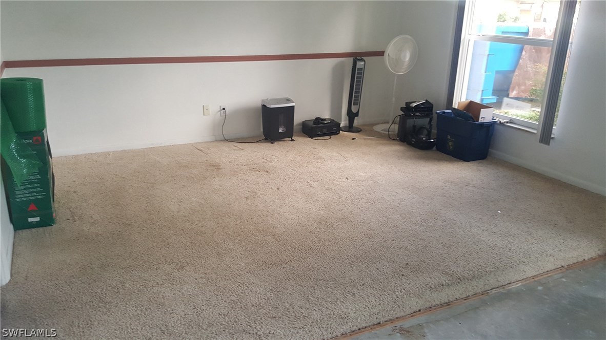 18024 Cypress Point Road Fort Myers, FL 33967 - Photo 8 of 21 an empty room with furniture and a window