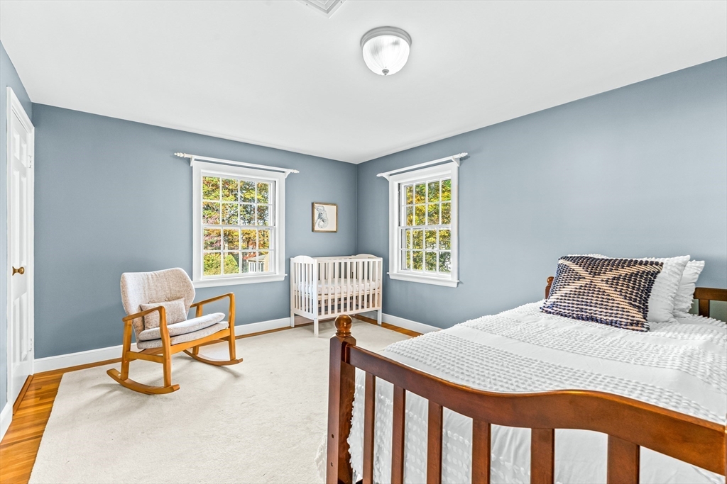 111 Pilgrim Road Wellesley, MA 02481 - Photo 11 of 21 a bedroom with a bed a table and chair