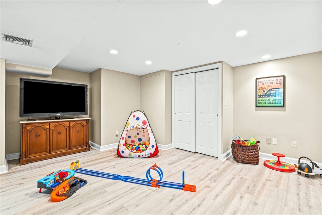 111 Pilgrim Road Wellesley, MA 02481 - Photo 15 of 21 a living room with furniture and a flat screen tv