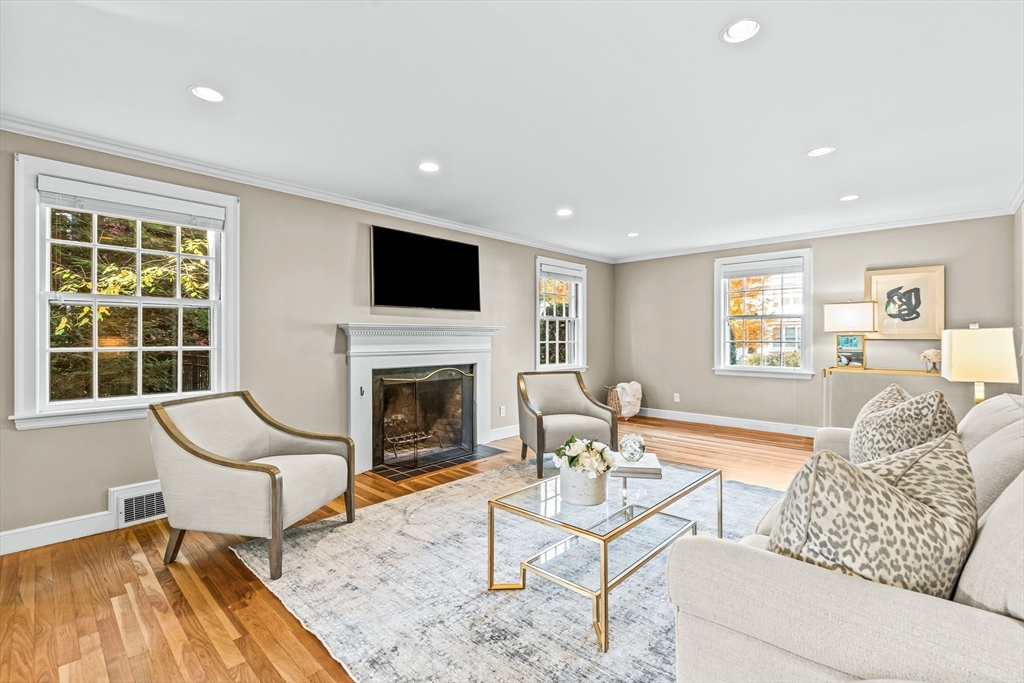 111 Pilgrim Road Wellesley, MA 02481 - Photo 2 of 21 a living room with furniture a fireplace and a flat screen tv