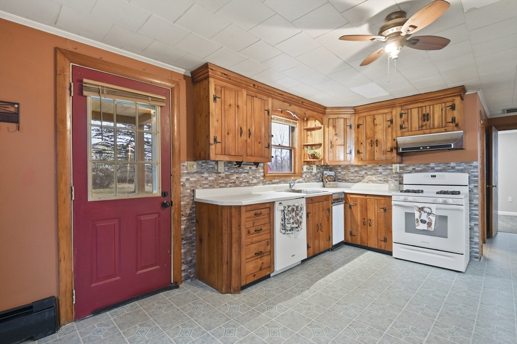 148 Lunenburg Road Townsend, MA 01474 - Photo 5 of 26 a kitchen with stainless steel appliances granite countertop a stove a sink and dishwasher with white cabinets