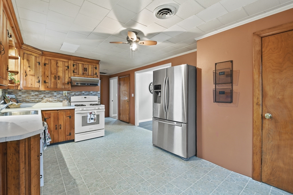 148 Lunenburg Road Townsend, MA 01474 - Photo 8 of 26 a kitchen with stainless steel appliances granite countertop a refrigerator and a stove top oven