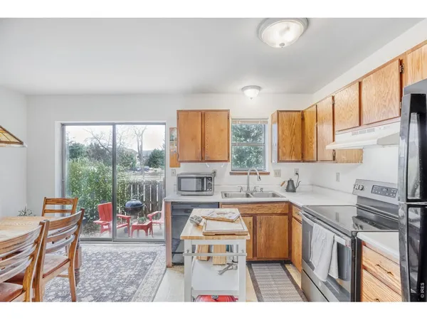a kitchen with a sink stove and wooden cabinets