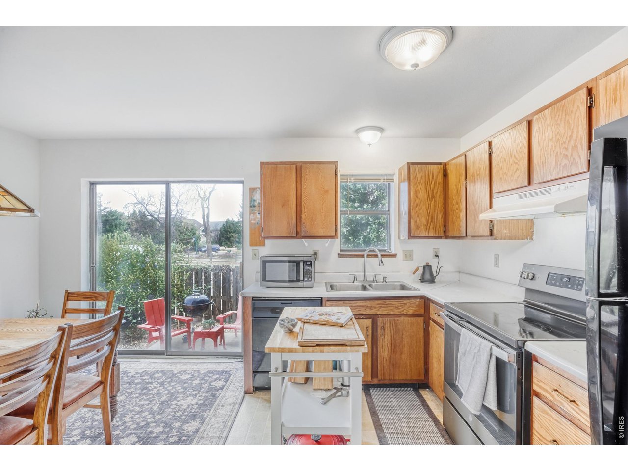 4690 Portside Way Boulder, CO 80301 - Photo 5 of 18 a kitchen with a sink stove and wooden cabinets