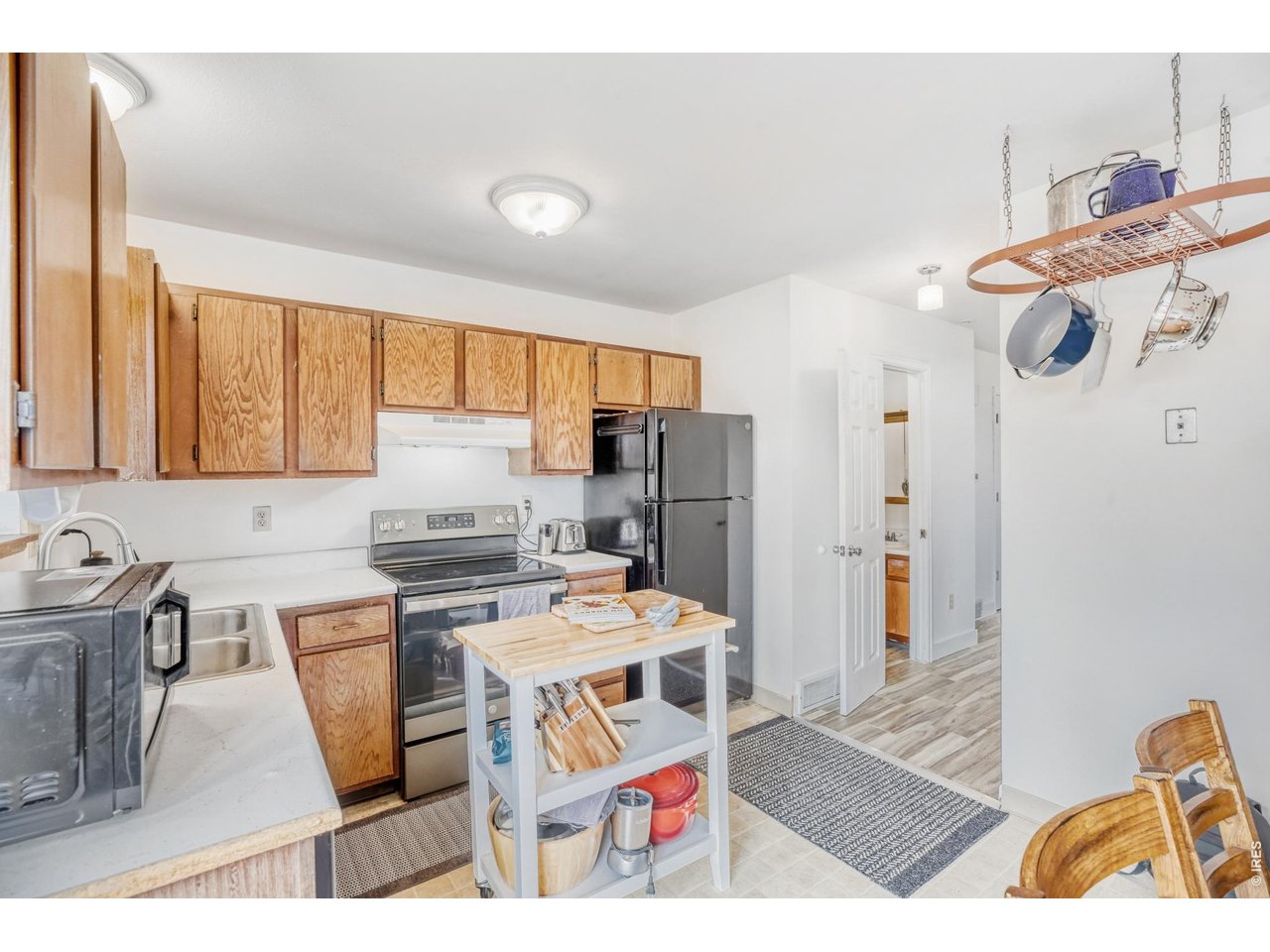 4690 Portside Way Boulder, CO 80301 - Photo 6 of 18 a kitchen with stainless steel appliances kitchen island granite countertop a sink stove and refrigerator