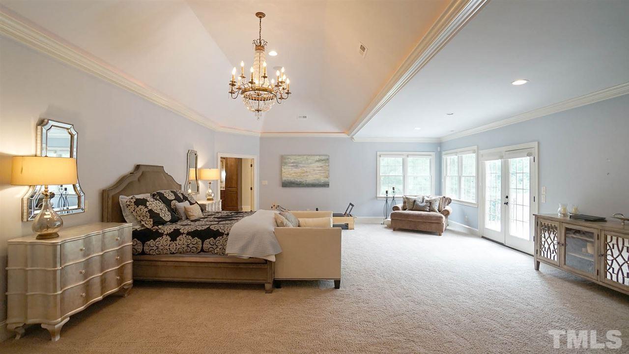 1608 Sharnbrook Court Raleigh, NC 27614 - Photo 14 of 30 Spectacular private renovated master wing addition w/vaulted trey ceiling & recessed lighting, 1,750 sq+, luxurious crystal chandelier, room for work out area, nursery, home office and so much more. Luxury custom closet. Private patio.