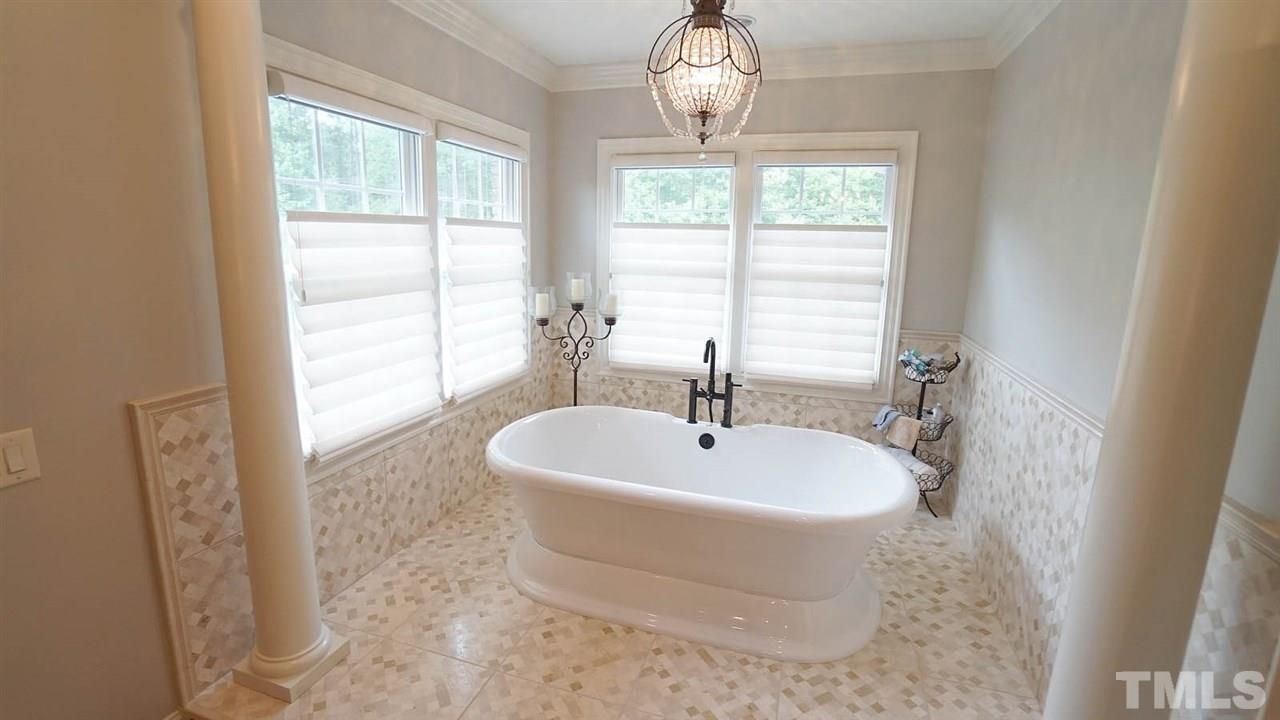 1608 Sharnbrook Court Raleigh, NC 27614 - Photo 18 of 30 Stunning oversized remodeled bathroom. Freestanding soaking tub w/2 walls of windows, intricate detail tile surround, w/spa like crystal chandelier