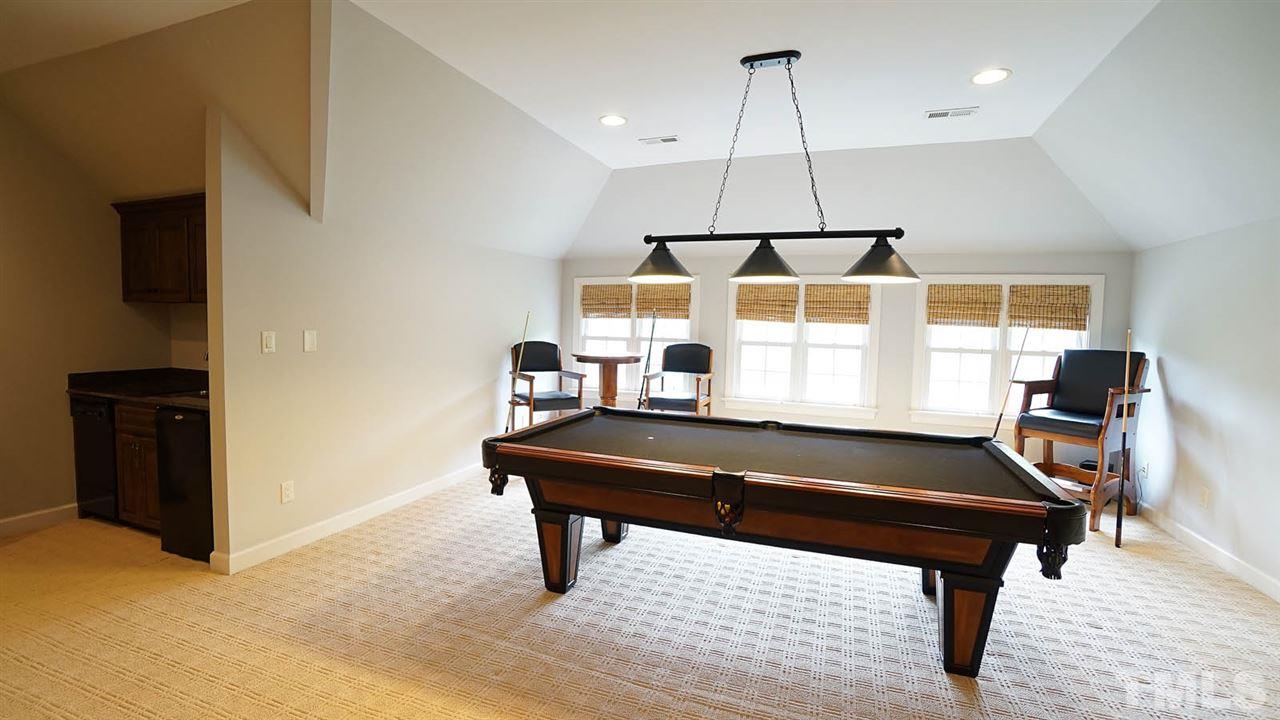 1608 Sharnbrook Court Raleigh, NC 27614 - Photo 23 of 30 Third floor rec room. Man cave, kids playroom, endless opportunities. Accessible via stairs and elevator. Wet bar with sink, dishwasher, and beverage fridge. Great views of backyard