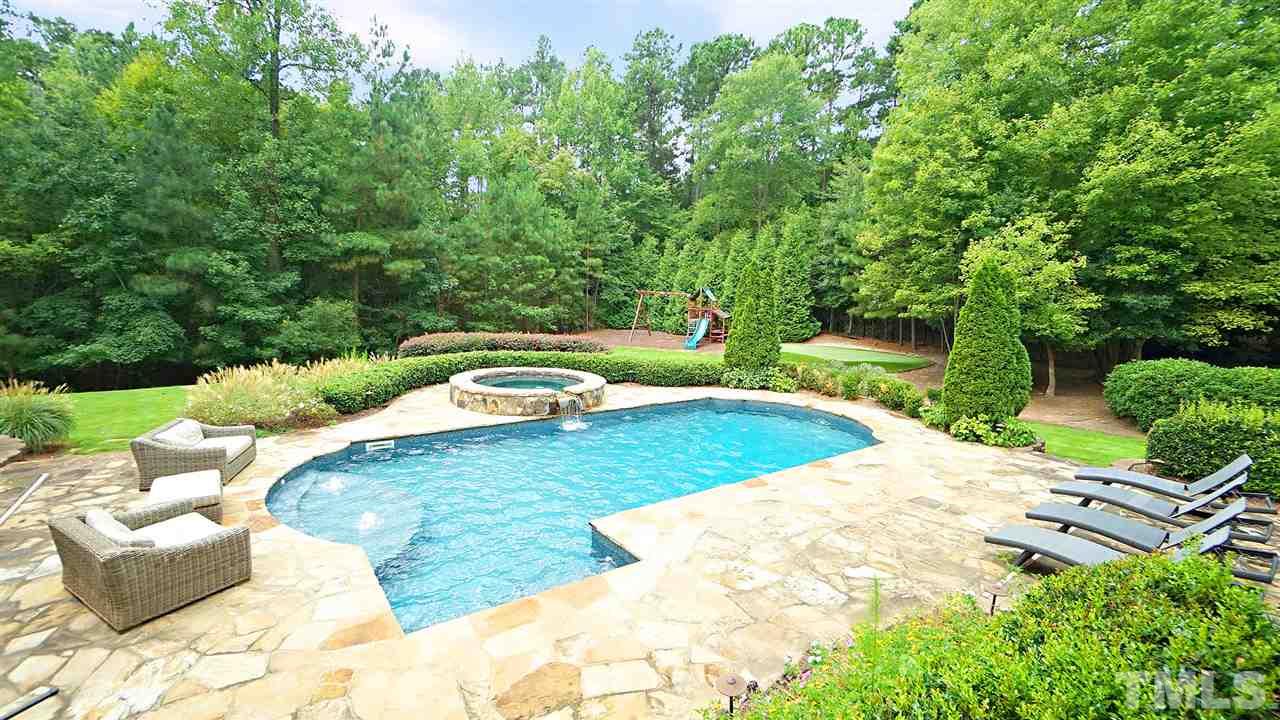 1608 Sharnbrook Court Raleigh, NC 27614 - Photo 4 of 30 Stone patio pool surround, playground, putting green, privacy