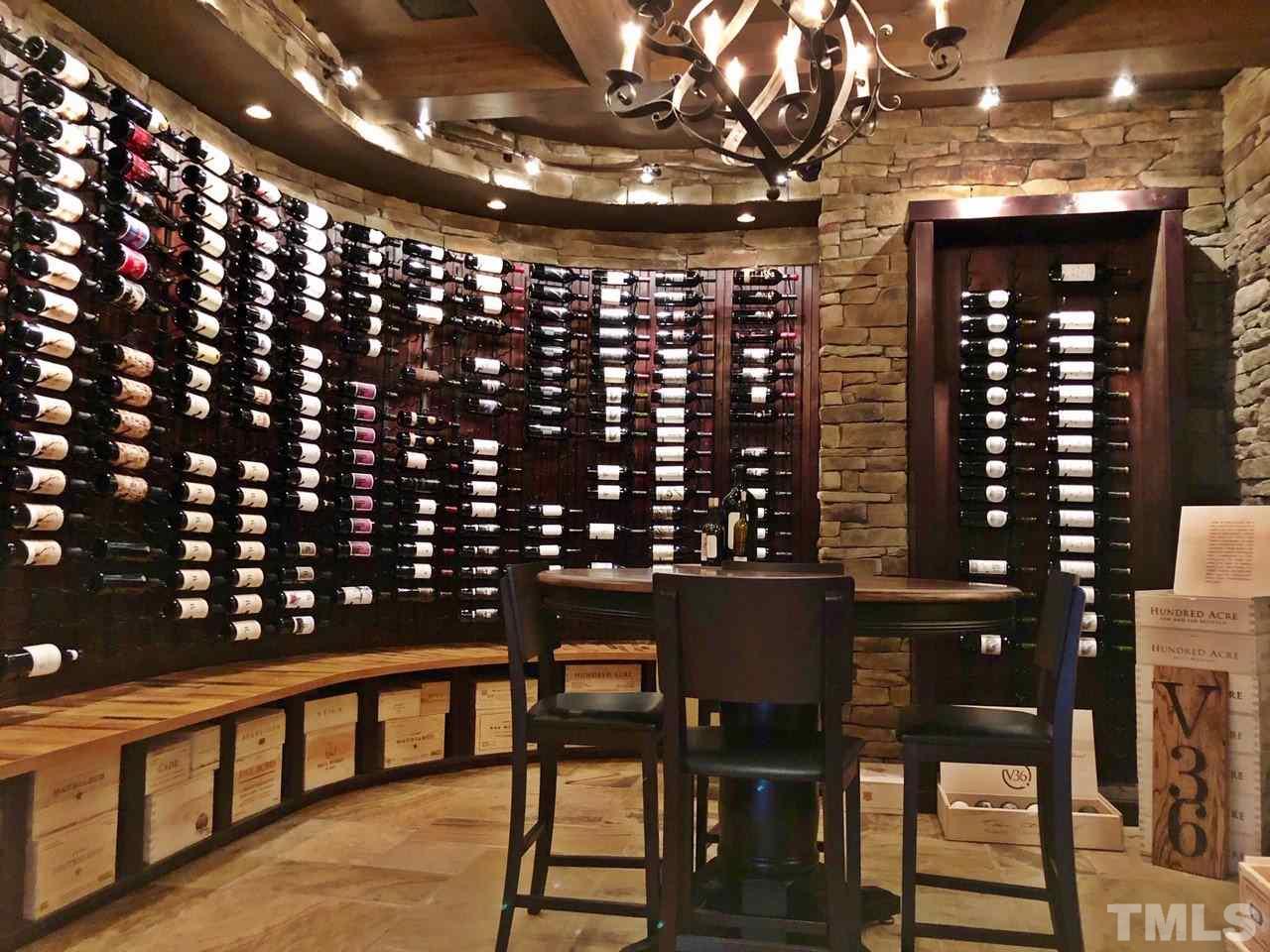 1608 Sharnbrook Court Raleigh, NC 27614 - Photo 9 of 30 1000 bottle temperature controlled custom wine cellar. Built in niches for special bottle display with recessed lighting. Tasting table, tile floor with old world look, built in cabinets and storage with win racks