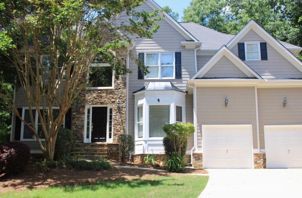 Undisclosed Address Suwanee, GA 30024 - Photo 1 of 1 a front view of a house with a yard and garage