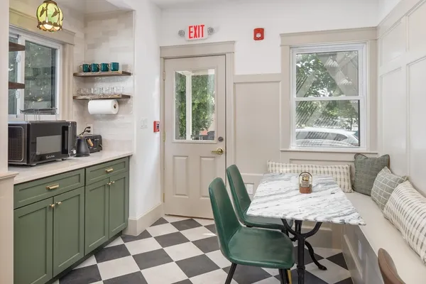 a view of a dining room with furniture a chandelier and wooden floor
