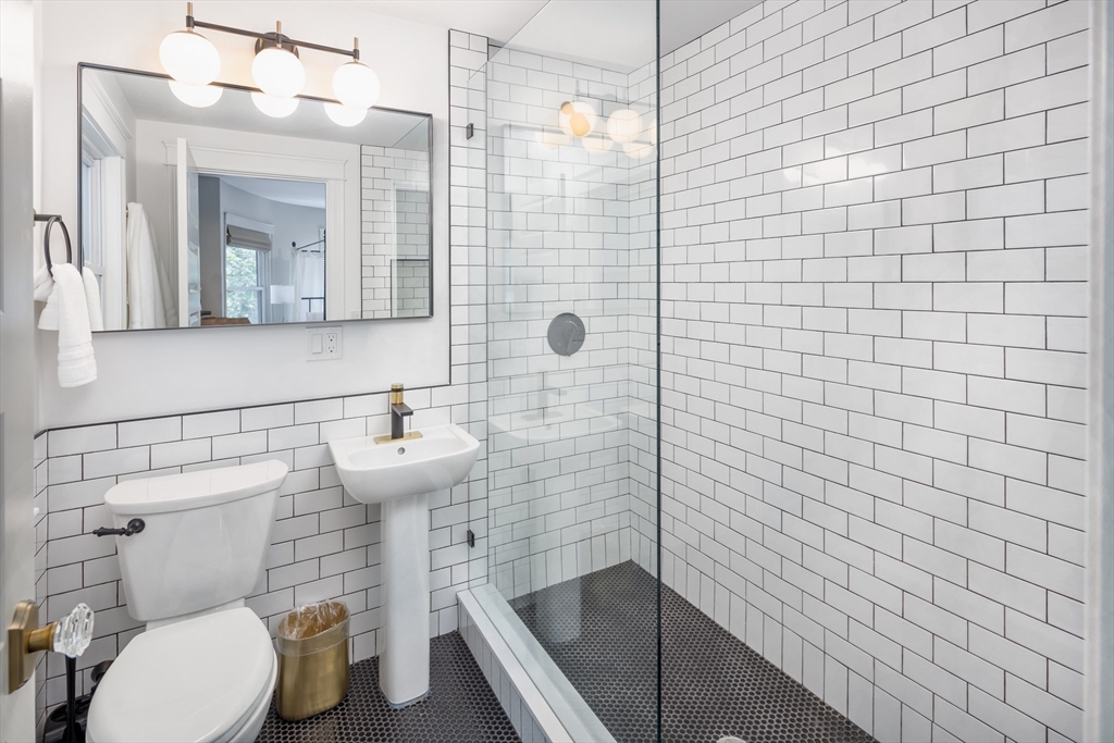 44 Winslow Road Brookline, MA 02446 - Photo 13 of 35 a bathroom with a toilet a sink and shower