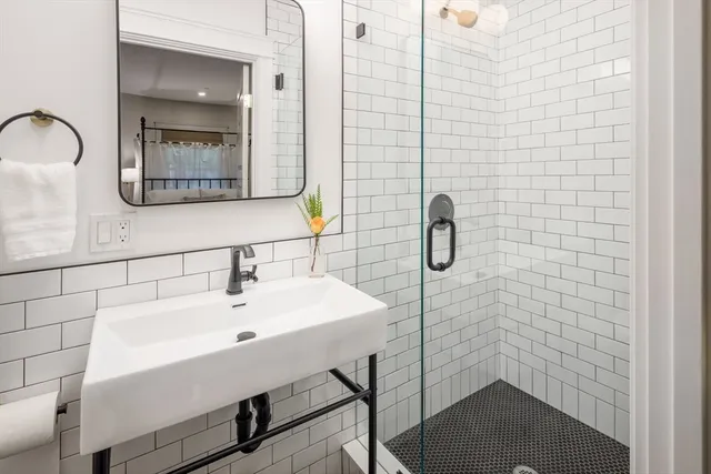 a bathroom with a sink a toilet and shower