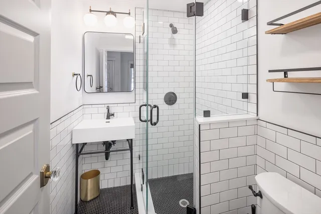 a bathroom with a sink a mirror and shower