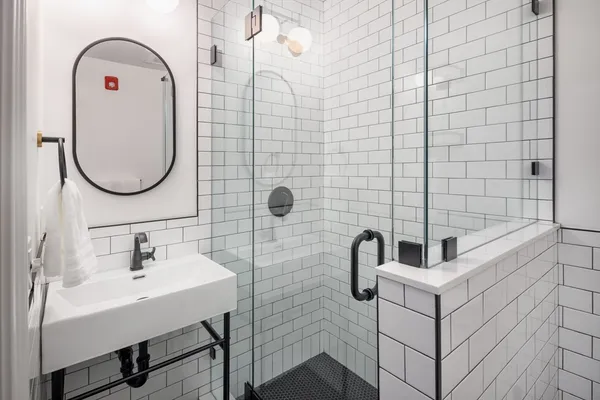 a bathroom with a sink mirror and a bathtub