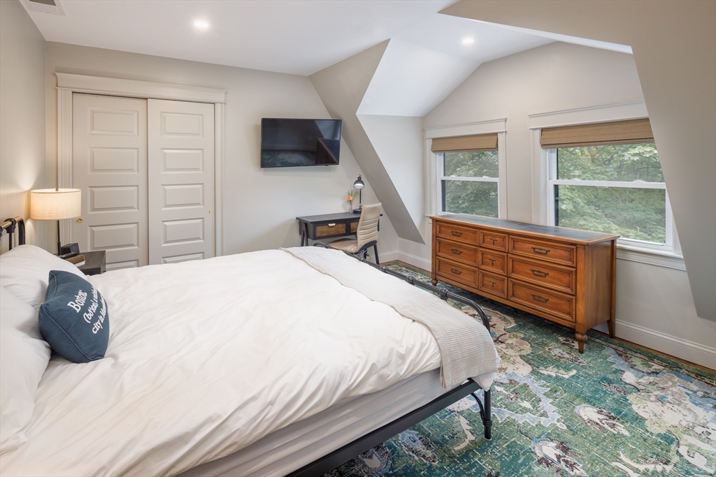 44 Winslow Road Brookline, MA 02446 - Photo 29 of 35 a bedroom with a bed a dresser and a large window