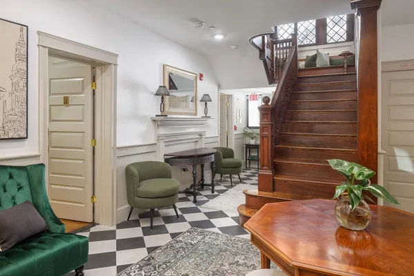 a dining room with furniture and wooden floor