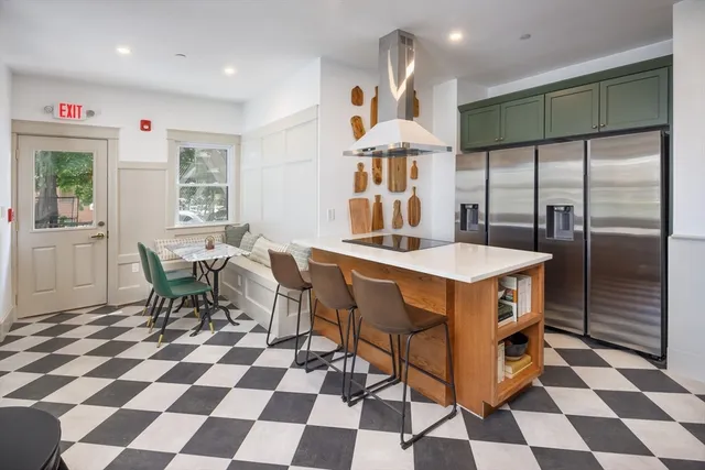 a dining room dining table chairs and a black white checkered floor