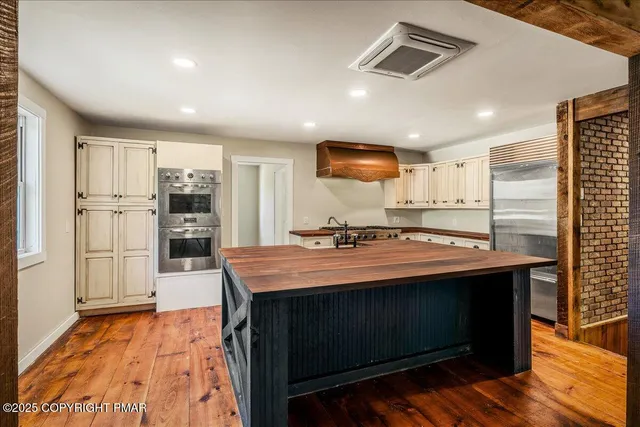 an empty room with closet and windows