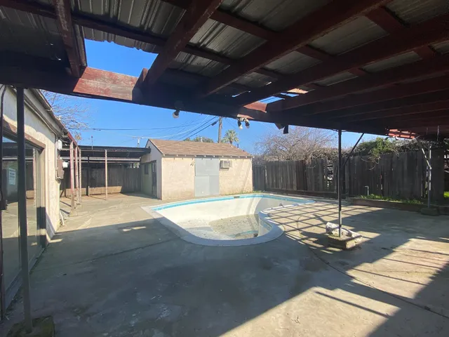 a view of a backyard with a tree