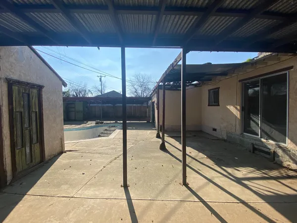 a view of an empty room with a fireplace and a window