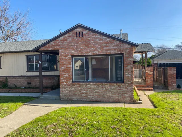 a front view of a house with a garden