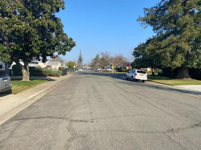 a view of a hallway with furniture and a refrigerator