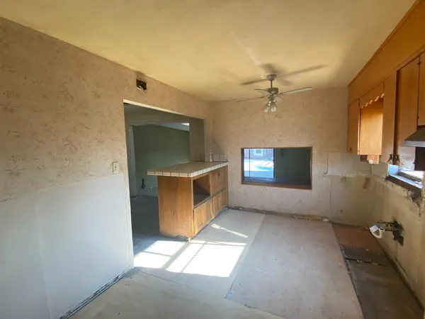 a view of an empty room with a fireplace and a window