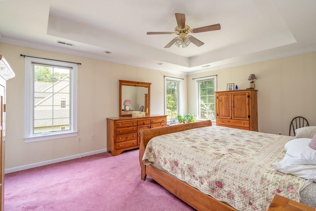 45 Gilbert Road Southampton, MA 01073 - Photo 19 of 36 a bedroom with a large bed a chandelier and dresser